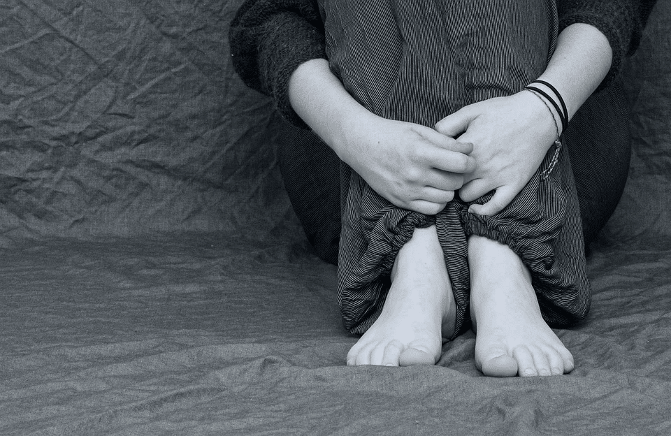 Feet and hands of a depressed girl