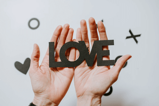 Person holding love word cutout