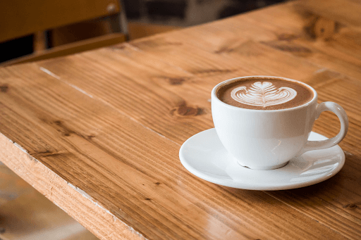 Photo of a cup of coffee on a wooden table