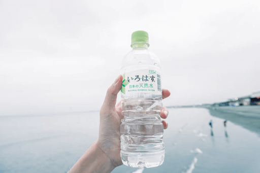 Hand of a person holding a plastic water bottle