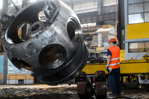 Man standing in front of a gray metal machine part