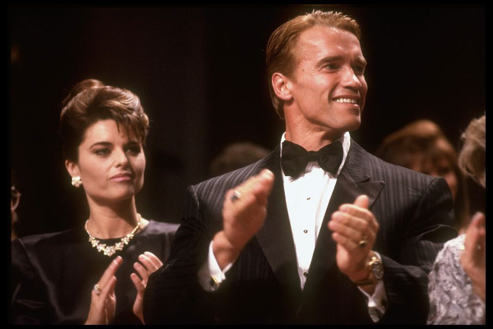 Arnold Schwarzenegger and wife Maria Shriver in black formal outfits for a Reagan event