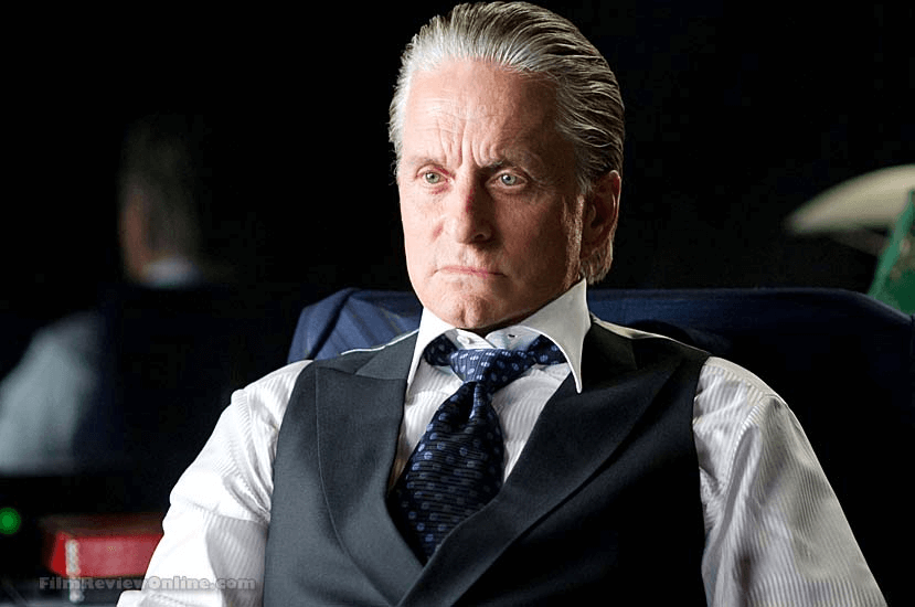 Old Gordon Gekko on a while long-sleeve polo and a black vest