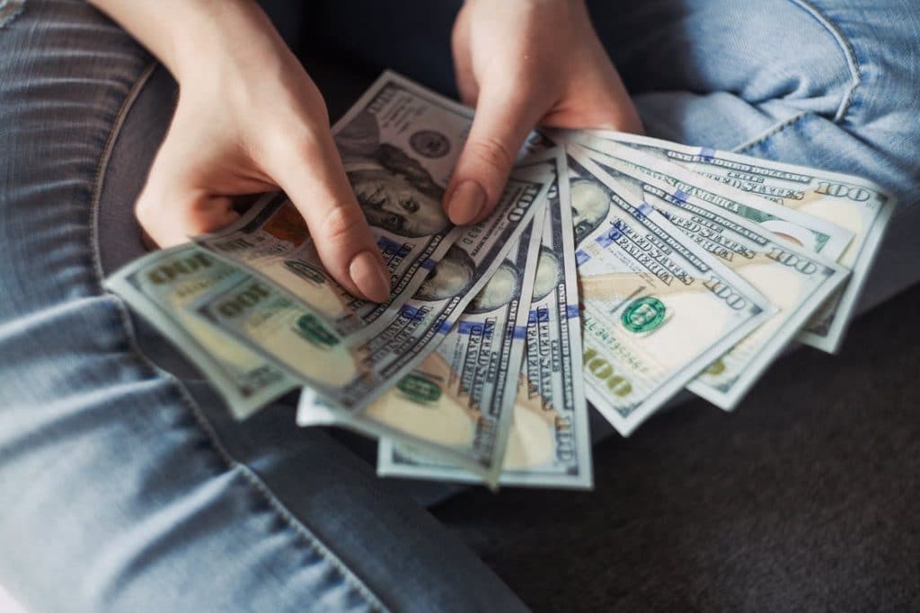 person holding nine 100 us dollar notes