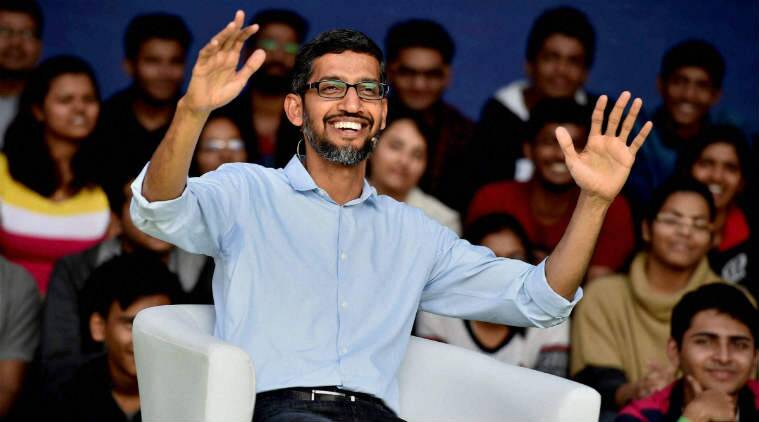 Sundar Pichai with a wide smile while raising both his arms