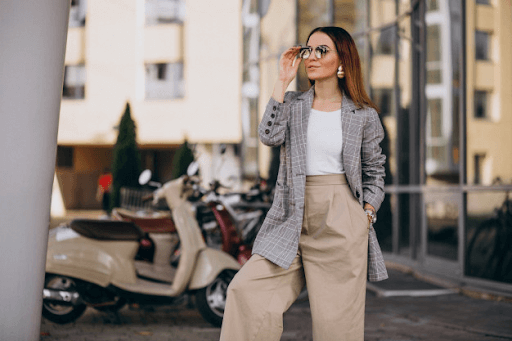 stylish classy woman wearing a gray checkered suit, khakis, and sunglasses