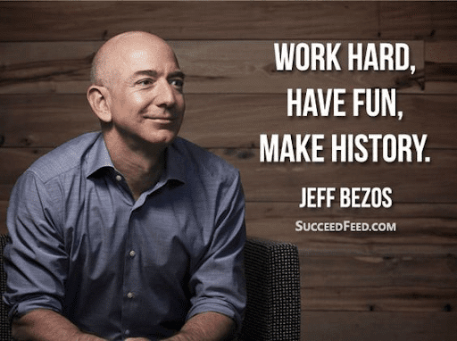 Jeff Bezos on a grey long-sleeve polo and the quote “Work hard, have fun, make history”