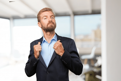 A businessman holding the collar of this black suit