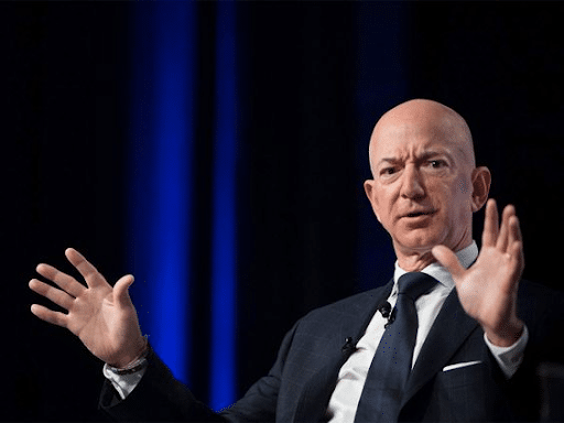 Frowning Jeff Bezos with both of his hands spread out