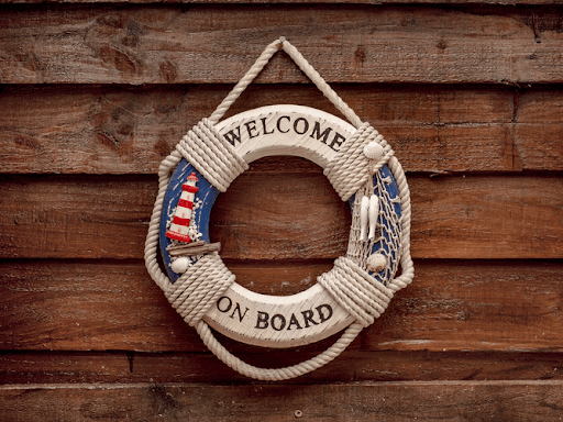  Round welcome on board ornament hanged on a wooden wall