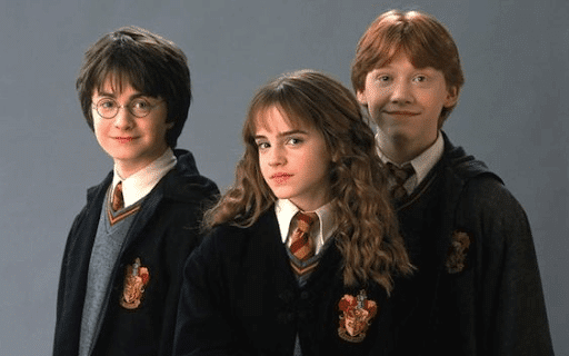 Harry, Hermione, and Ron wearing their Hogwarts uniforms