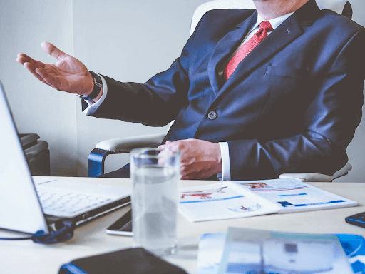 a man in suit watching his computer