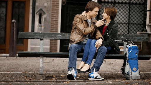 sweet moment between Gus and Hazel who are in a bench in Amsterdam