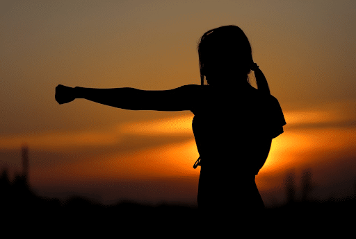 Silhouette of a woman practicing karate