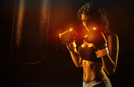 Girl boxer in front of a punching bag