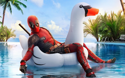Deadpool in an inflatable swan floater in a swimming pool (Deadpool 2 image)