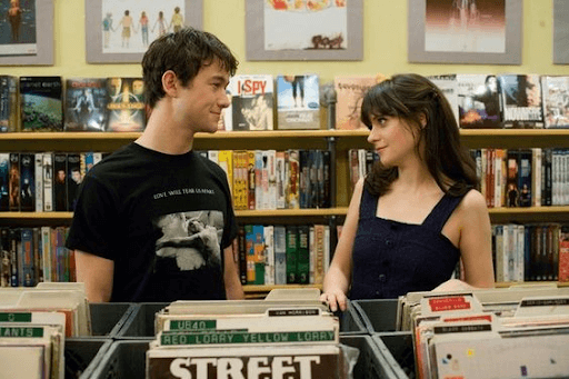 Tom and Summer smiling at each other in the library