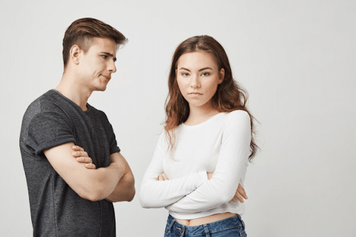  Young couple in white and grey top arguing