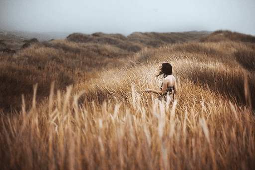 Woman on a foggy grass field