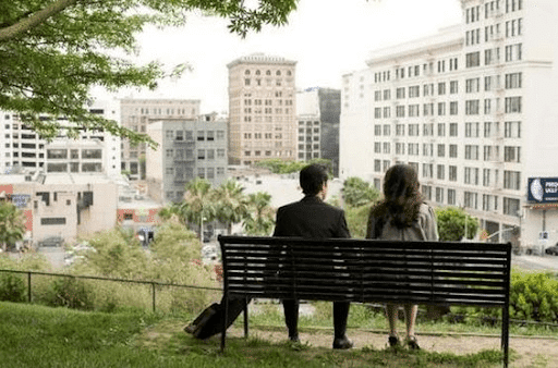 Back view of Tom and Summer sitting on a bench