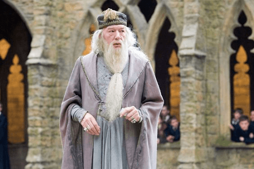  Dumbledore standing and surrounded by Hogwarts students