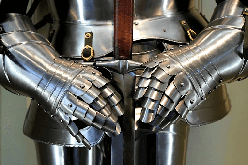 Gray medieval knight armor holding a sword