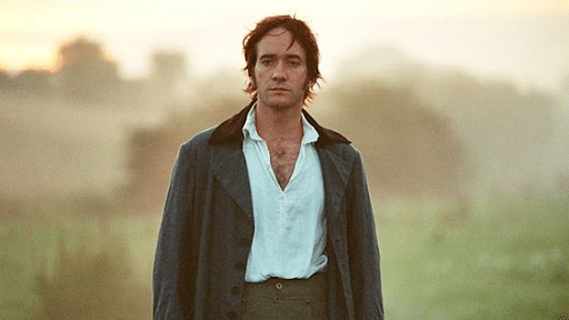 Mr. Darcy wearing a white top and grey coat with a seemingly sad face