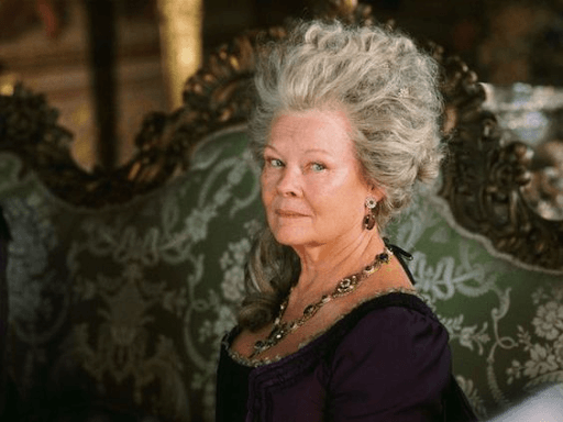 Lady Catherine de Bourgh wearing a purple dress sitting on a green sofa designed with white flowers