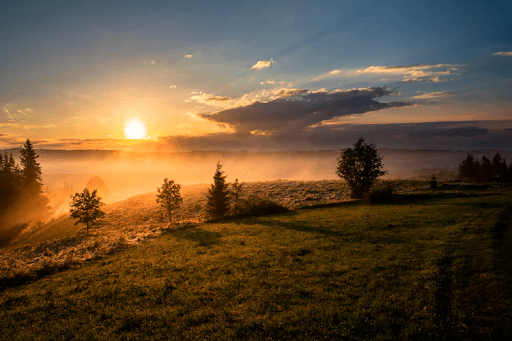 Sunset at the top of a foggy mountain