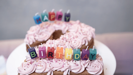 Number 2-shaped brown birthday cake with purple flower icing