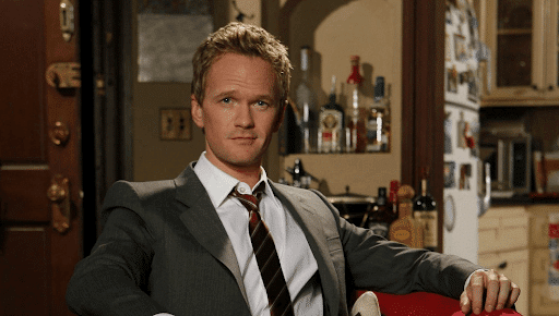 Barney Stinson in a suit with a slight smirk