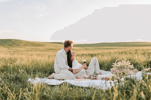  Man and woman sitting on a grass field