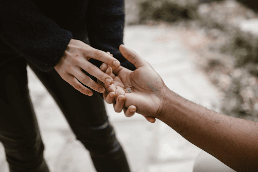 Woman giving back a ring to the man’s palm