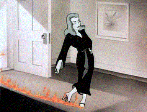 a woman in a black dress walking, and her path burning after she’s walked through it