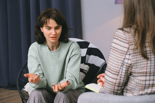 Female Talking with Psychologist During Session