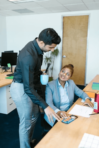 Man in a Shirt Talking With a Female coworker