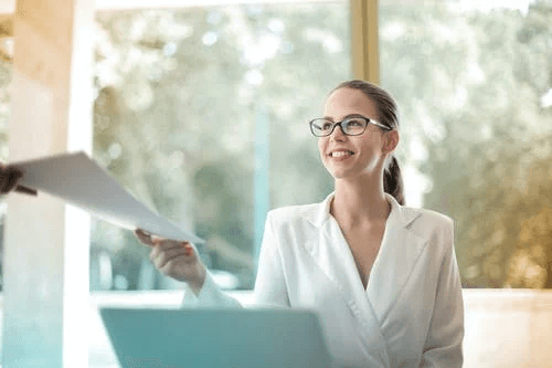 Positive Businesswoman Doing Paperwork in Office