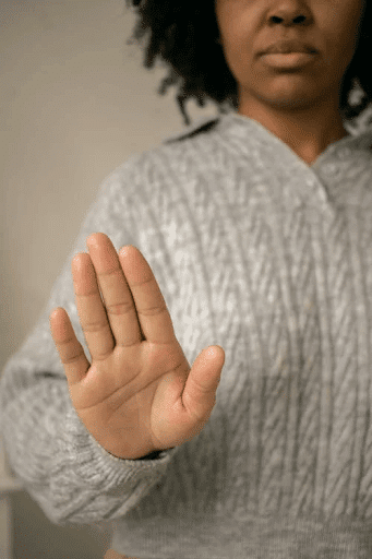  Black Woman Showing Palm in Light Room