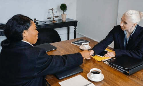  Cheerful Colleagues Shaking Hands in Office